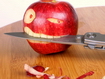 Apple Biting A Knife